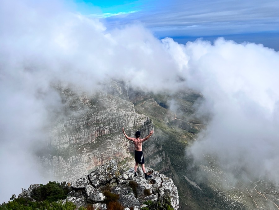 Logan on a summit above the clouds